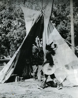 First Nations men with tent and drum