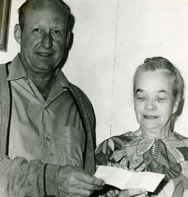 Man and woman with cheque [?]