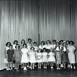 Performers in front of curtain