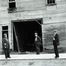 Men in front of building