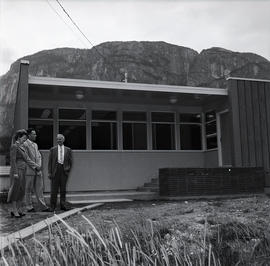 Men and woman in front of new-looking building