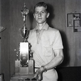 Man with Loggers Sports trophy