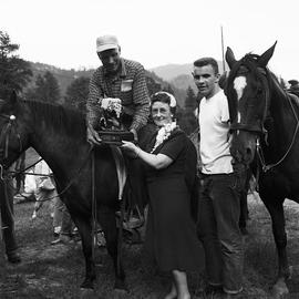 Man on horse with award