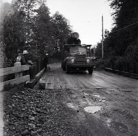 Logging truck crossing bridge