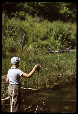 Scout fishing from dam