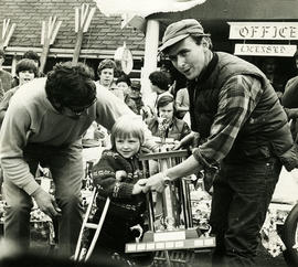 Men and child with trophy