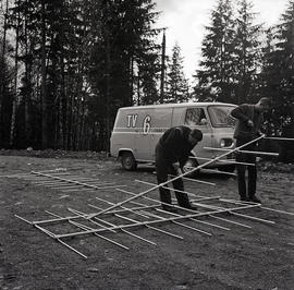 TV van and men assembling something