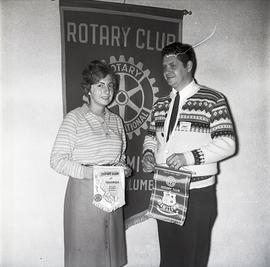 People with Rotary Club sign